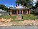 Charming brick home with a front porch and well-maintained landscaping at 119 Hemlock Ave, Kannapolis, NC 28081
