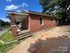 Brick home exterior showcasing a side porch and multiple windows at 119 Hemlock Ave, Kannapolis, NC 28081