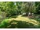 A spacious backyard with lush greenery, surrounded by mature trees, and partial view of home at 124 Julius Ln, Mooresville, NC 28117