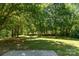 A large green yard is shaded by tall trees, creating a tranquil outdoor space at 124 Julius Ln, Mooresville, NC 28117