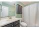 A full bathroom features a vanity, cabinet, and shower with a curtain at 124 Julius Ln, Mooresville, NC 28117