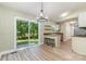 Eat-in kitchen area with stylish chandelier, bar seating, and sliding glass doors leading to the backyard at 124 Julius Ln, Mooresville, NC 28117