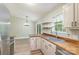 The kitchen area is updated with butcher block counters, stainless appliances, and a breakfast nook at 124 Julius Ln, Mooresville, NC 28117