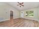 Bright living room featuring laminate floors, neutral walls, and plenty of natural light from a large window at 124 Julius Ln, Mooresville, NC 28117