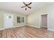 Cozy living room featuring laminate floors, fresh paint, a ceiling fan and large window for natural light at 124 Julius Ln, Mooresville, NC 28117