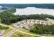 Aerial view of lakeside community featuring beautiful homes, mature trees and lake access at 1300 Dali Blvd, Mount Holly, NC 28120