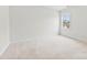 A peaceful bedroom filled with natural light from a large window overlooking verdant surroundings at 1300 Dali Blvd, Mount Holly, NC 28120