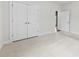 A well-lit bedroom with carpet, closet, and doorway, offering a calm and inviting atmosphere at 1300 Dali Blvd, Mount Holly, NC 28120