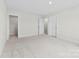Clean bedroom features neutral carpet, closet with wire rack, and multiple doors at 1300 Dali Blvd, Mount Holly, NC 28120