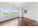 Bright dining room features large windows with trim, modern chandelier and hardwood floors at 1300 Dali Blvd, Mount Holly, NC 28120