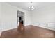 Dining area featuring hardwood floors, chair railing, and modern lighting at 1300 Dali Blvd, Mount Holly, NC 28120