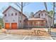 Stunning wood clad exterior with garage and covered porch, featuring striking orange window and door trim at 1300 Dali Blvd, Mount Holly, NC 28120