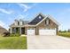 Charming brick home featuring a three-car garage, dormers, and a manicured lawn at 1300 Dali Blvd, Mount Holly, NC 28120
