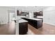 Spacious kitchen with dark wood cabinets, a large island, and hardwood floors at 1300 Dali Blvd, Mount Holly, NC 28120