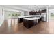Open kitchen featuring dark wood cabinets, a large center island, and stainless steel appliances at 1300 Dali Blvd, Mount Holly, NC 28120