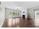 Living area features hardwood floors, a fireplace, and natural light from the windows at 1300 Dali Blvd, Mount Holly, NC 28120