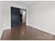 Bright living area with hardwood floors, sliding barn door and open entry to other rooms at 1300 Dali Blvd, Mount Holly, NC 28120