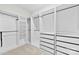 Spacious walk-in closet featuring custom shelving, drawers, and ample storage space for organized living at 1300 Dali Blvd, Mount Holly, NC 28120