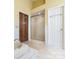 Bathroom featuring a glass enclosed shower, soaking tub, and wood-look tile flooring at 13037 Angel Oak Dr, Huntersville, NC 28078