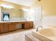 Well-lit primary bathroom featuring dual sinks, separate shower, and a large soaking tub at 13037 Angel Oak Dr, Huntersville, NC 28078