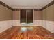 Cozy bedroom with hardwood floors, wainscoting, and serene natural light at 13037 Angel Oak Dr, Huntersville, NC 28078