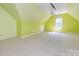 Spacious bonus room with carpet, angled ceiling, and window at 13037 Angel Oak Dr, Huntersville, NC 28078