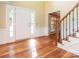 Bright foyer featuring hardwood floors, staircase with wood and iron railing and a front door with sidelights at 13037 Angel Oak Dr, Huntersville, NC 28078