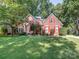Classic brick home with red shutters and a well-manicured lawn, creating a welcoming curb appeal at 13037 Angel Oak Dr, Huntersville, NC 28078