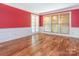 Inviting living room featuring hardwood floors, wainscoting, and French doors at 13037 Angel Oak Dr, Huntersville, NC 28078