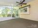 Screened-in porch with ceiling fan and access to outdoor deck at 13037 Angel Oak Dr, Huntersville, NC 28078