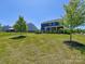 Beautiful backyard with lush green grass, well-placed trees, and a view of the home's covered patio at 1324 Mona Vale Dr, Huntersville, NC 28078