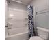 White bathroom features a shower/tub combo with white shower head and a floral curtain at 1324 Mona Vale Dr, Huntersville, NC 28078