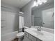 Clean bathroom with shower-tub combo, neutral wall color, and white sink cabinet at 1324 Mona Vale Dr, Huntersville, NC 28078