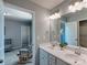 Bathroom with double sinks with modern vanity, a large mirror, and access to an adjacent bedroom at 1324 Mona Vale Dr, Huntersville, NC 28078