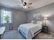 Comfortable bedroom with a ceiling fan, neutral color scheme, and a picturesque window view at 1324 Mona Vale Dr, Huntersville, NC 28078