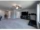 Spacious bonus room with a ceiling fan and a large tv above a modern console table, plus exercise equipment at 1324 Mona Vale Dr, Huntersville, NC 28078