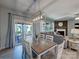 Bright dining area open to the living room features an elegant light fixture and sliding door access to the patio at 1324 Mona Vale Dr, Huntersville, NC 28078