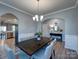 Elegant dining room featuring a dark wood table with seating for six and modern light fixture at 1324 Mona Vale Dr, Huntersville, NC 28078
