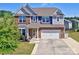 Charming two-story home showcasing a well-maintained lawn, a two-car garage, and inviting curb appeal at 1324 Mona Vale Dr, Huntersville, NC 28078
