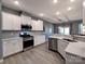 Bright and modern kitchen showcasing stainless steel appliances, white cabinetry, and ample counter space at 1324 Mona Vale Dr, Huntersville, NC 28078