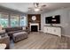 Welcoming living room features a fireplace with wood accents, a large TV, and ample natural light at 1324 Mona Vale Dr, Huntersville, NC 28078