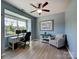 Serene home office space with a large window, modern desk setup, and comfortable seating area at 1324 Mona Vale Dr, Huntersville, NC 28078