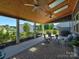 Covered patio area with skylights, ceiling fans, stone floors, and cozy seating at 1324 Mona Vale Dr, Huntersville, NC 28078
