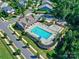 Aerial view of a community pool area featuring a pool, playground, and lounge chairs at 1324 Mona Vale Dr, Huntersville, NC 28078