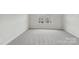 Carpeted bedroom with light neutral colors and one window at 135 Utility Ln # E, Mooresville, NC 28117