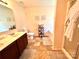 Well-lit bathroom with double vanity, tiled floor, bathtub, and a glass shower door at 1528 Magnolia Dr # 8, Lancaster, SC 29720