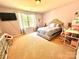 Comfortable bedroom featuring neutral walls, a plush bed, window with natural light, and modern decor at 1528 Magnolia Dr # 8, Lancaster, SC 29720
