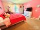 Cozy bedroom designed with pink walls, white furniture, plush decor, and a comfy bed at 1528 Magnolia Dr # 8, Lancaster, SC 29720