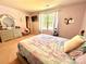 Bedroom featuring neutral walls, a large window, and a comfortable upholstered bed at 1528 Magnolia Dr # 8, Lancaster, SC 29720