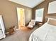 Inviting bedroom with an open doorway, comfortable chair, side table, and soft lighting at 1528 Magnolia Dr # 8, Lancaster, SC 29720